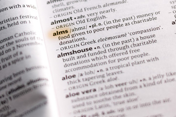 Ivanovsk, Russia - November 19, 2018: The word or phrase Alms in a dictionary.