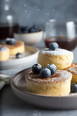 fluffy Japanese pancake for breakfast with blueberries , icing sugar and coffee 