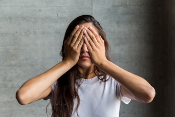 Young Woman Covering Eyes with Hands