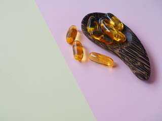 Fish oil capsules on colored background, Cod liver oil omega 3 gel capsules, Vitamin And Dietary...