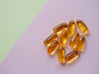 Fish oil capsules on colored background, Cod liver oil omega 3 gel capsules, Vitamin And Dietary...