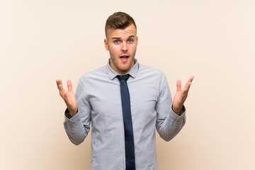 Young blonde businessman over isolated background with surprise facial expression