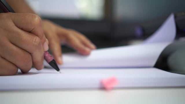 Asian Business man Manager checking and signing applicant filling documents reports papers company application form or registering claim on desk office. Document Report and business busy Concept