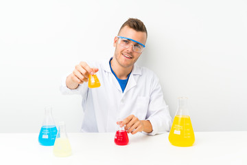 Happy Young scientific with lots of laboratory flask