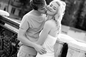 Young couple cuddling while walking in love