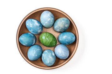 Different easter eggs in ceramic bowl isolated on white