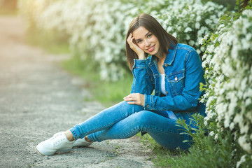 Obraz premium Attractive young woman outdoors. Close up portrait of beautiful female.