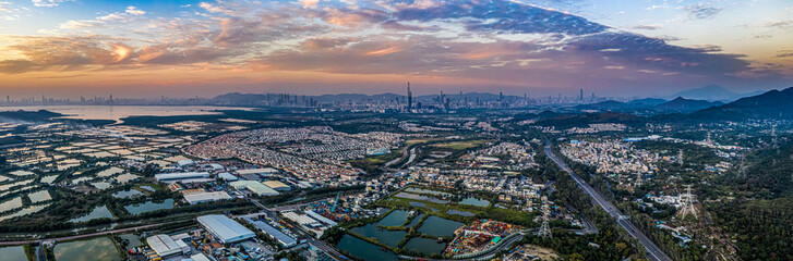 Fototapeta na wymiar Aerial View of rural green fields in Hong Kong border and skylines in Shenzhen,China