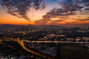 Fototapeta na wymiar Aerial View of rural green fields in Hong Kong border and skylines in Shenzhen,China