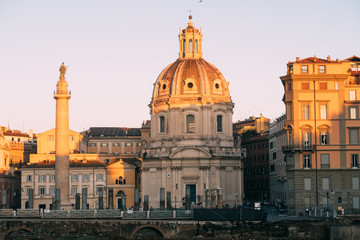 Fototapeta na wymiar Rome, Italy - Jan 2, 2020: Trajan's Column (UNESCO World Heritage Site) in Trajan's Forum and church of Santa Maria di Loreto, Rome, Lazio, Italy