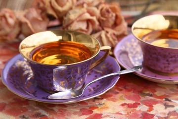 Pink tea in pink gold-coated cup On a pink saucer and a silver spoon On Valentine 's Day