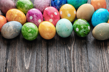 Different easter eggs on wooden background