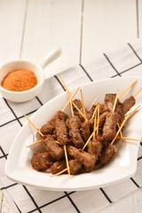 Barbecue made of beef with bamboo sticks