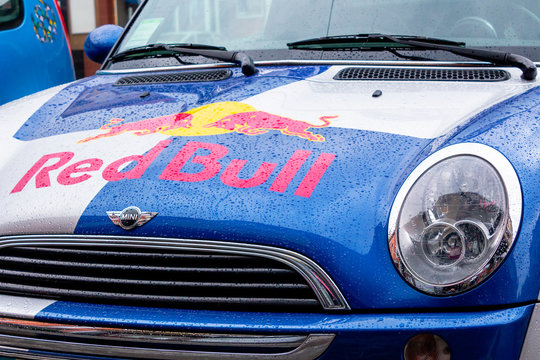 Uzhhorod, ukraine - 14 JUL, 2013: Red Bull mini cooper publicity car detail. fancy car tuning used for promotion. wet advertisement vehicle after the rain