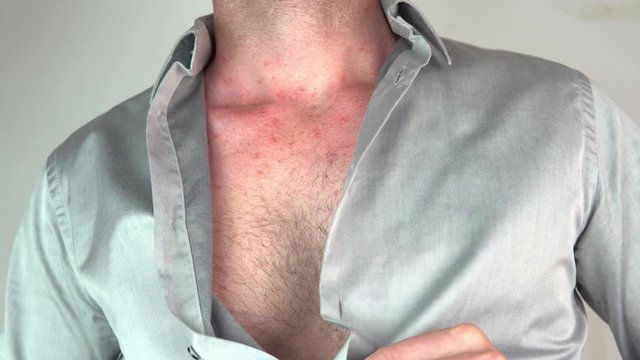 Caucasian man taking off blue shirt