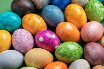 Different easter eggs on green table