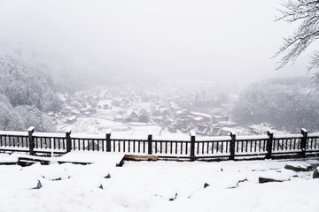 Shirakawa-go villages snowfall day, Gifu prefecture Japan. Shirakawago famous Gassho-zukuri houses steep thatched roofs, Village hill view point in snowing fall winter, inscribed UNESCO World Heritage