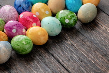 Fototapeta na wymiar Different easter eggs on wooden background