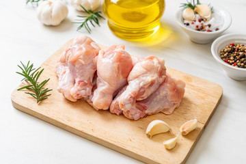 fresh raw chicken wings (drumette or drumstick) on wooden board