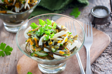 Salad with pumpkin and seaweed in glass creams on a wooden table, selective focus