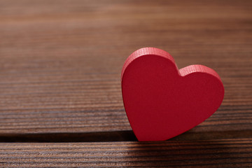 Red heart on wooden background. Valentine's day background.