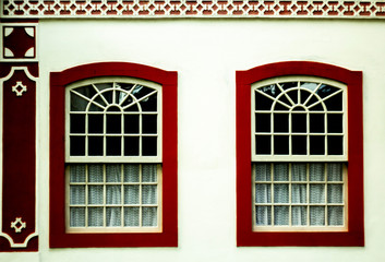 Beautiful windows with national pattern on the white wall in the historical center of Paraty, Brazil