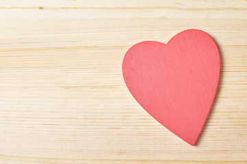 Red heart on wooden background