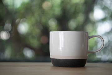 White ceramic cup on wood table