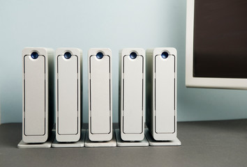 computer file concept, station consisting of 5 large aluminum hard drives, aligned on black table...