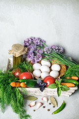 Naklejka na ściany i meble Vegetables assortment: carrot, tomatoes, cucumbers, fennel, garlic in the basket. Harvest background. Healthy vegetarian food concept.