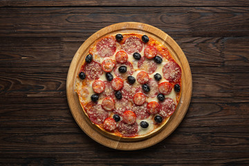 Stages of making pizza. Salami pizza