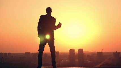 back view ambitious man in the early morning looking on orange sunrise slow motion
