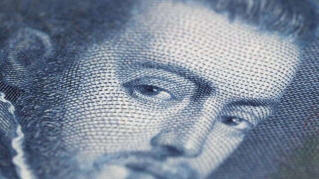 King Philip II of Spain portrait on vintage Spanish 100 peseta (1925) banknote rotating. Low angle, macro. 4K, 422 10 bit