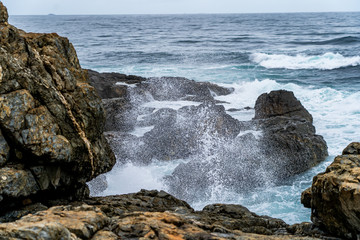 Ocean spray and rocky sea