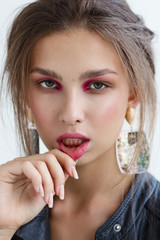 Portrait of young beautiful woman wearing earrings with perfect makeup