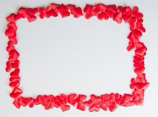 Silk hearts on a white background in a frame