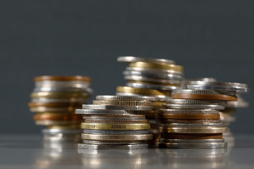 Coins are stacked against grey background
