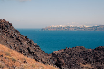Fototapeta na wymiar View on the Nea Kameni volcano island near Santorini island at sunny weather at Greece