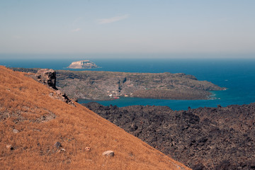 View on the Nea Kameni volcano island near Santorini island at sunny weather at Greece