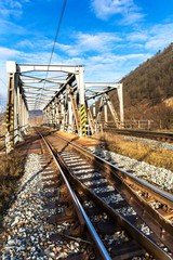Obraz premium Metal railway bridge over the Svratka River near the town of Tisnov in the Czech Republic - EU. Transport on rails. Railway transport infrastructure.