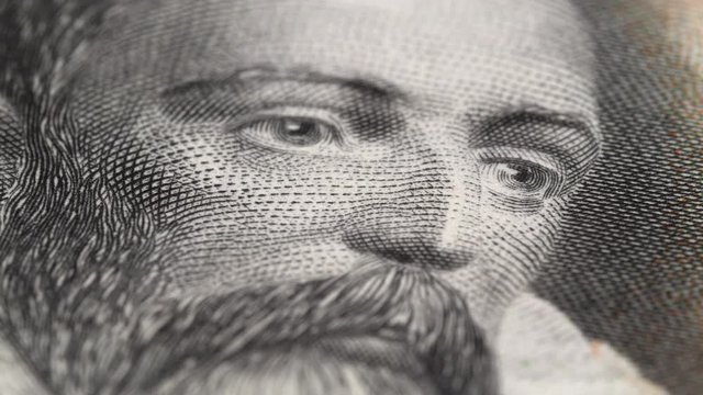 Miguel de Cervantes portrait on Spain 100 pesetas banknote (1928) rotating. Famous Spanish writer. Low angle, macro. 4K, 422 10 bit