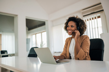 Portrait of a charming mixed-race customer support operator at work.