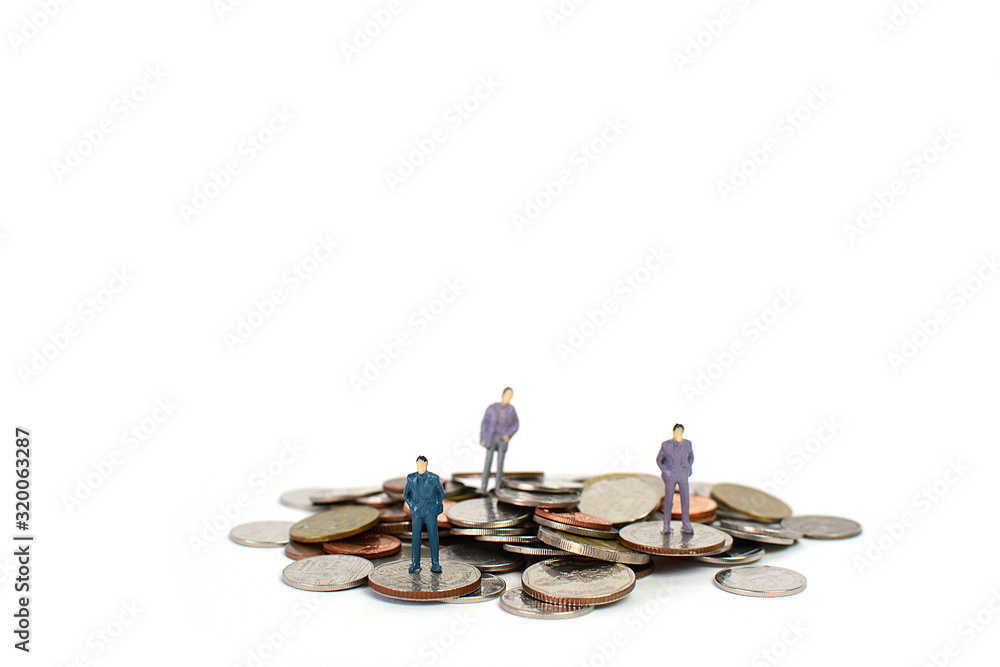 Wall mural miniature figures businessman on coins, on the white backgroud.