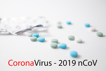 colourful medicine pills with hand. Coronavirus treatment concept