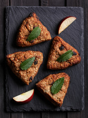 Fitness dessert with apple and raisins on a dark background