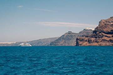 Fototapeta na wymiar View on the Santroini island harbor and cliffs at sun weather