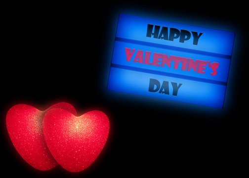 Rote gl&uuml;hende Herzen und Leuchtkasten mit dem Text HAPPY VALENTINES DAY isoliert auf schwarzem Hintergrund