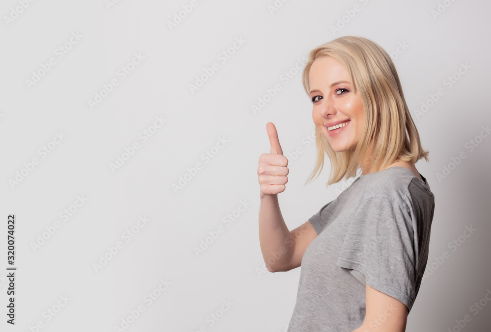 Wall mural beautiful blonde woman show ok gesture on white background