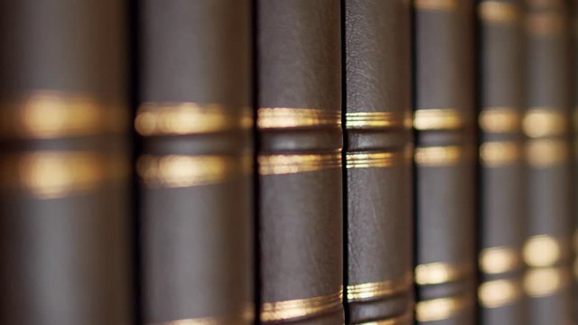 Books on the table in library, shallow depth of field. Books with a luxurious leather binding. 4k