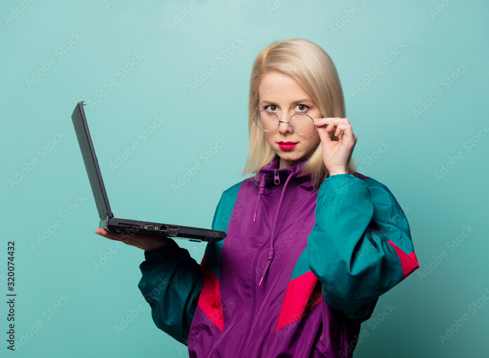 Poster style blonde woman in glasses with laptop computer